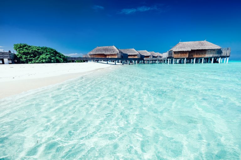 Summer hotel with houses standing in the water on Maldives